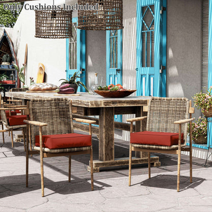 Outdoor dining set with wooden table and chairs on a patio, featuring red cushions.
