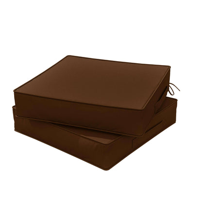Two stacked brown outdoor chair cushions with side ties and handles