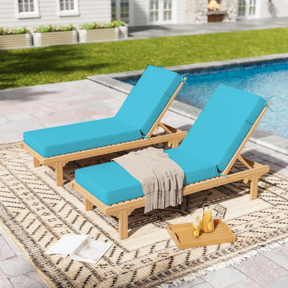 Two wooden lounge chairs with blue cushions by a poolside.