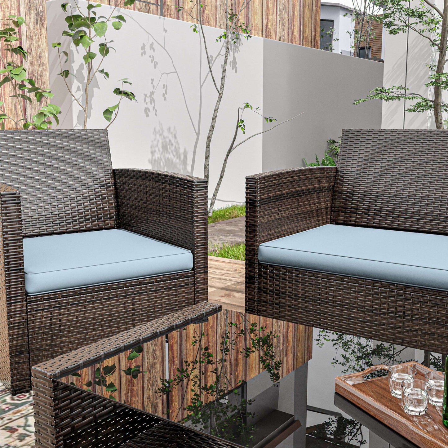 Outdoor patio with brown wicker chairs and blue cushions around a glass coffee table