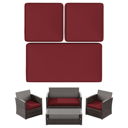 Outdoor wicker patio furniture set with red cushions, including sofa, two armchairs, and coffee table