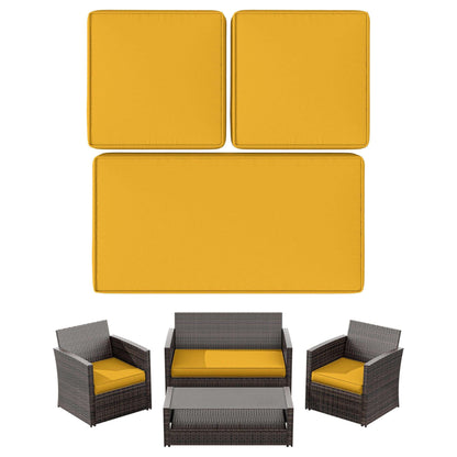 Outdoor rattan patio furniture set with mustard yellow cushions and a glass top coffee table