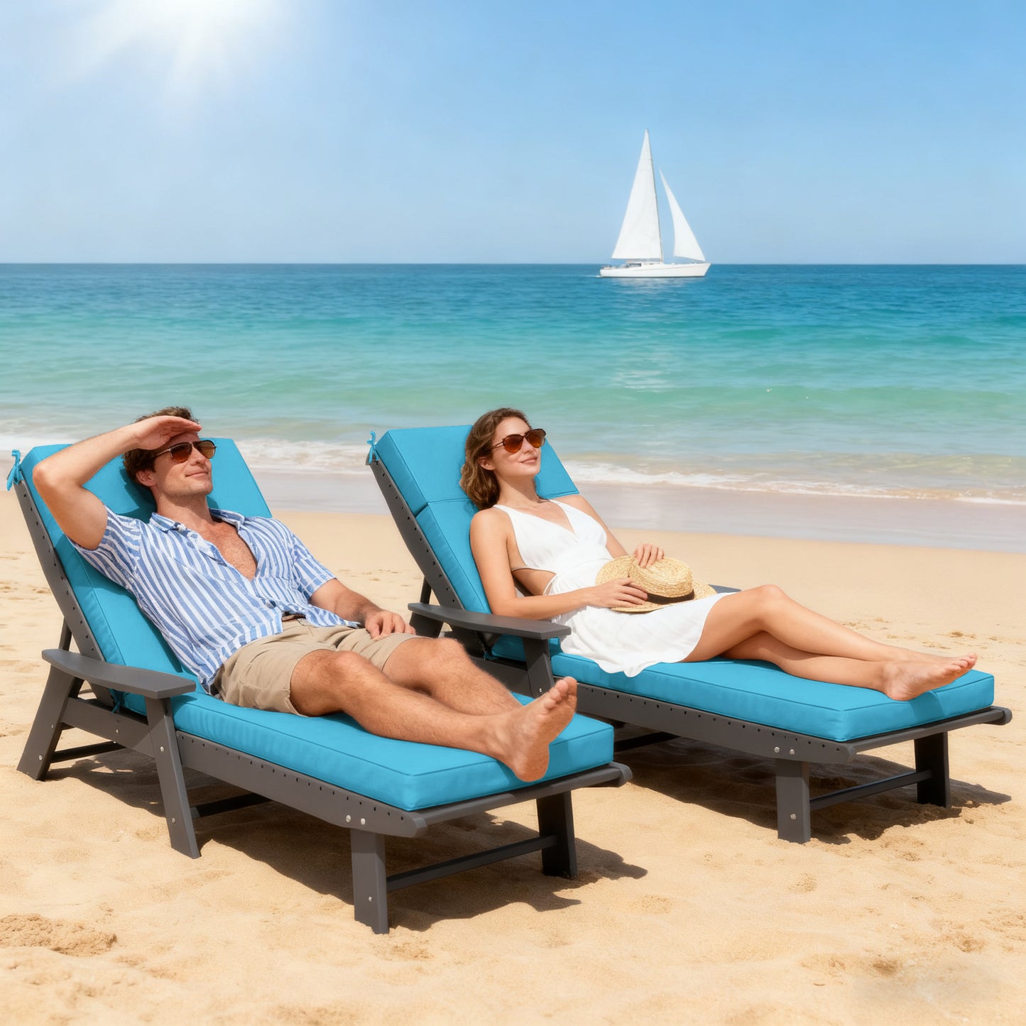 Two people relaxing on blue beach chairs with a sailboat in the background.