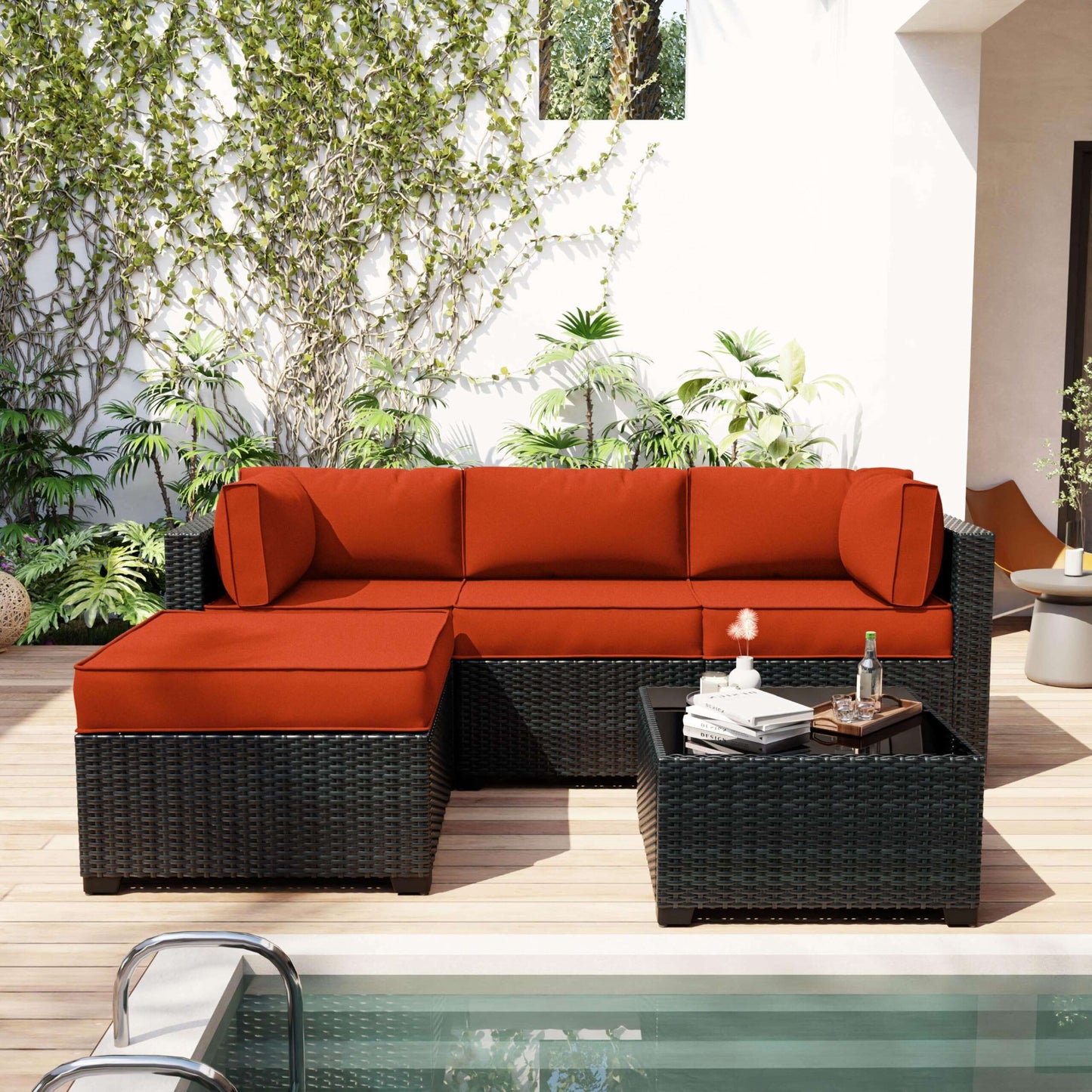 Outdoor patio furniture set with red cushions by a pool