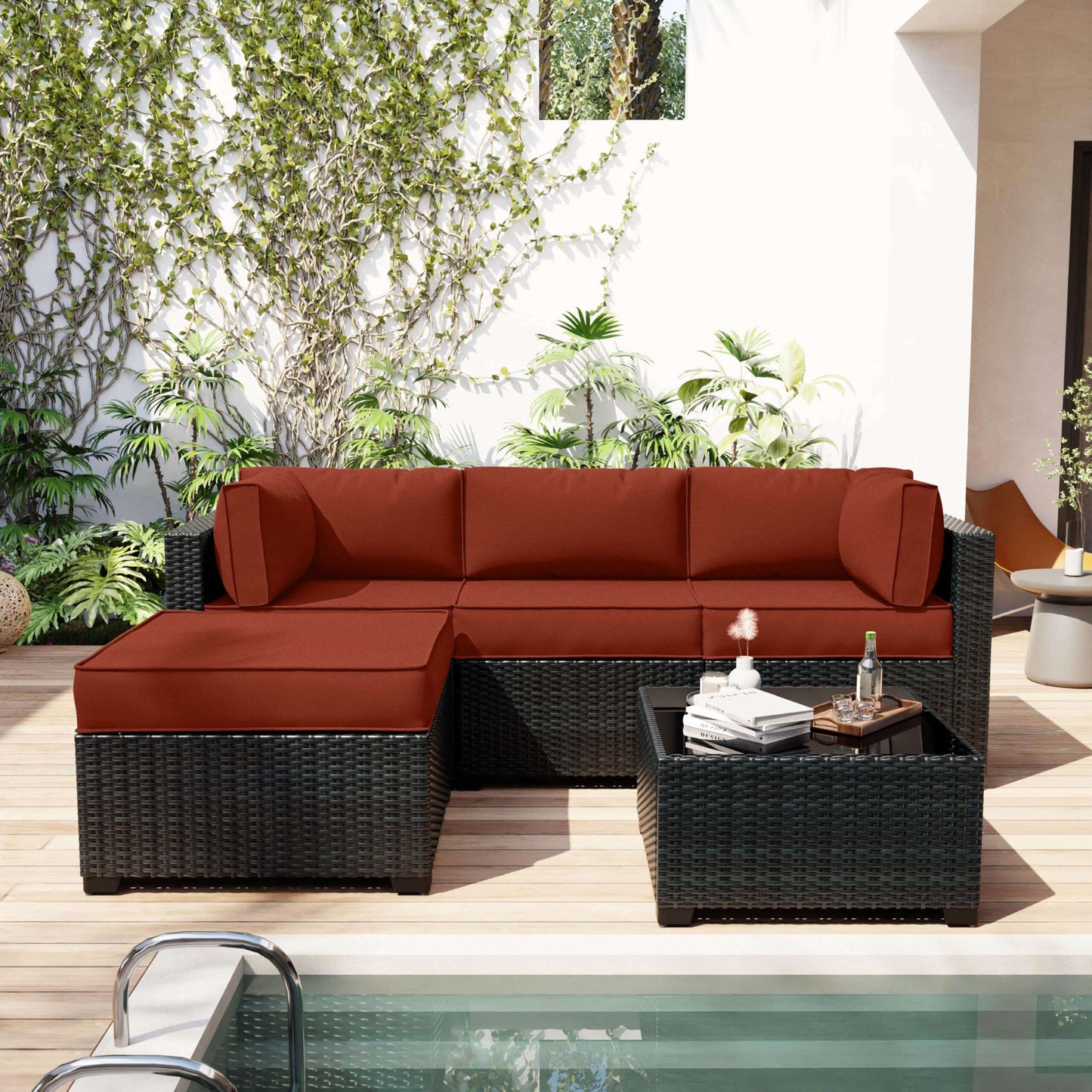 Outdoor patio furniture set with red cushions by a pool
