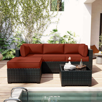 Outdoor patio furniture set with red cushions by a pool