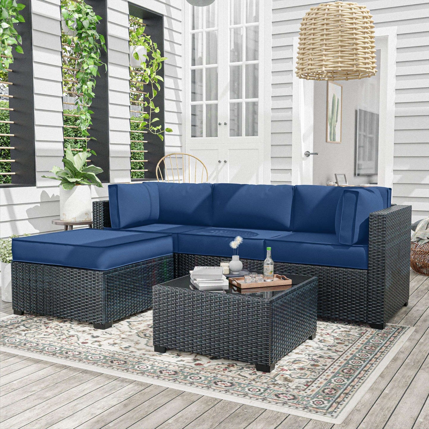 Blue outdoor sectional sofa with matching ottoman on a patio