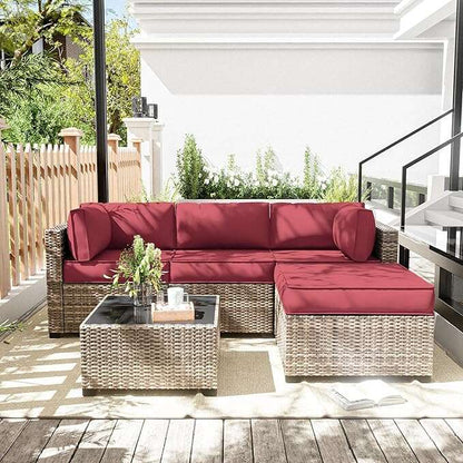 Outdoor patio set with red cushions on a wooden deck