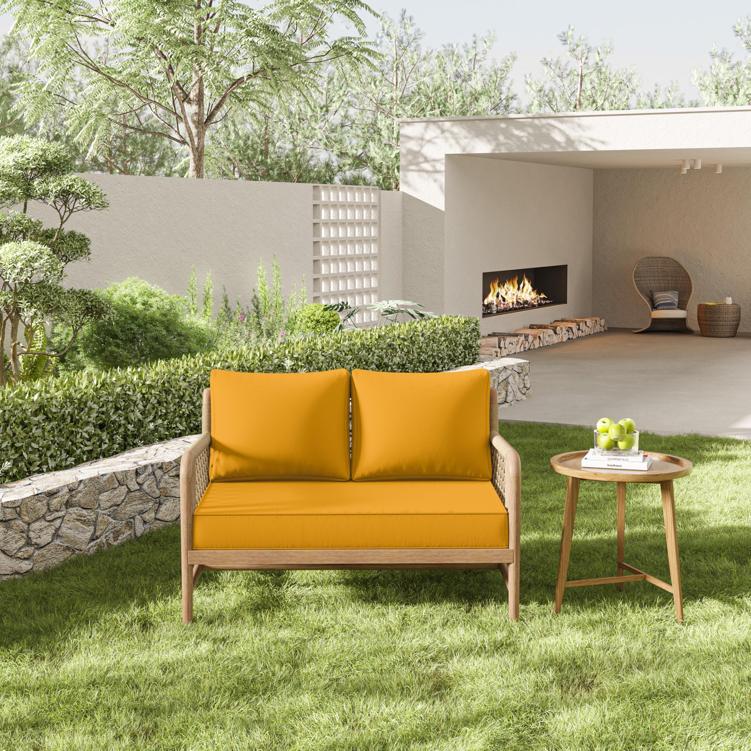 Outdoor yellow loveseat cushion on a wooden chair and a small table in a garden.