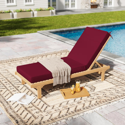 Wooden lounge chair with burgundy cushions by a poolside on a patterned rug.