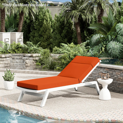 Outdoor lounge chair with orange cushions by a poolside with palm trees and greenery.