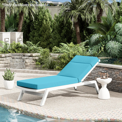 Blue cushioned outdoor lounge chair with white frame on a patio with pool and garden view.