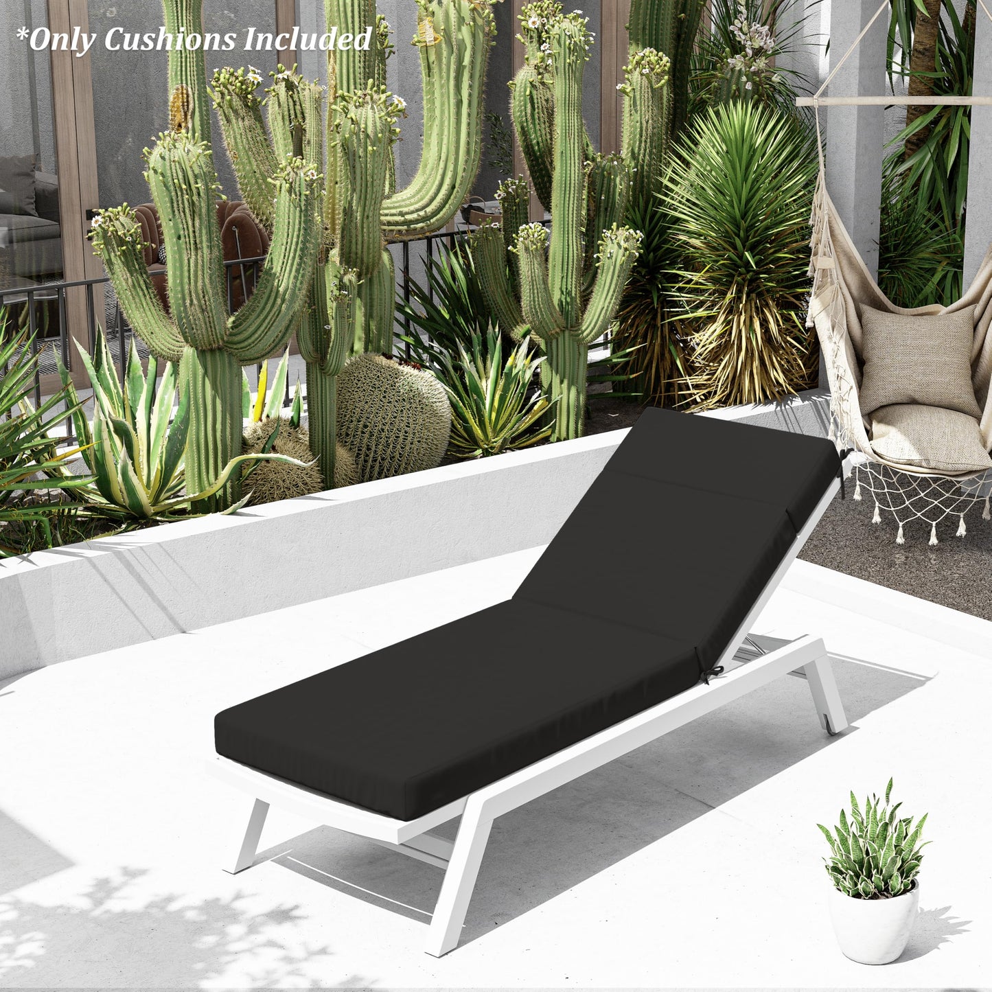 Black cushioned lounge chair on a patio with cacti and plants in the background