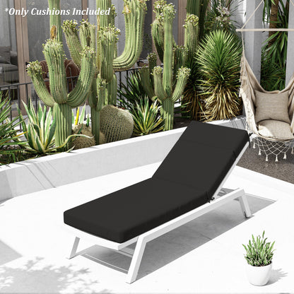 Black cushioned lounge chair on a patio with cacti and plants in the background