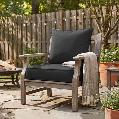 charcoal cushions on wooden chair in the backyard with firepit and blanket