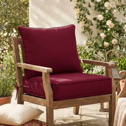 burgundy cushions in a cozy patio setting with plants and flowers