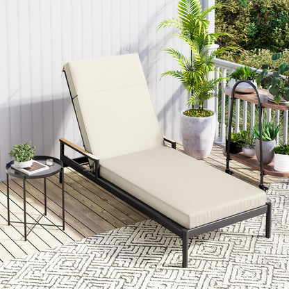 Beige lounge chair on a balcony with plants and a small table.