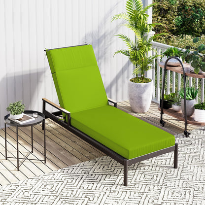 Green outdoor lounge chair on a patio with plants and a small table.