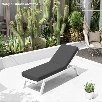 Outdoor lounge chair with gray cushions in a garden setting with cacti and plants.