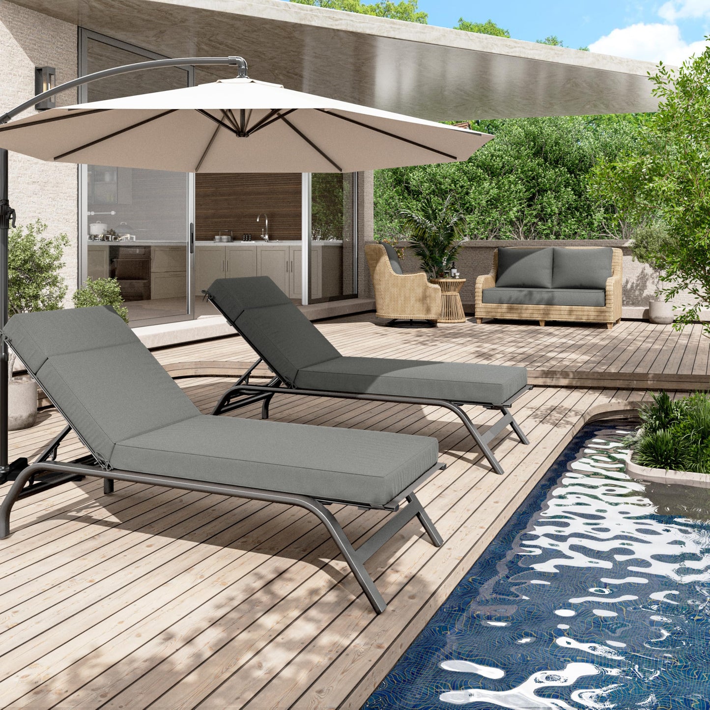 Outdoor patio with gray lounge chairs, umbrella, and poolside view