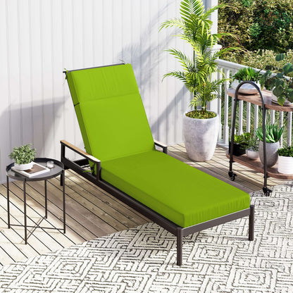 Green outdoor lounge chair on a patio with plants and a small table.