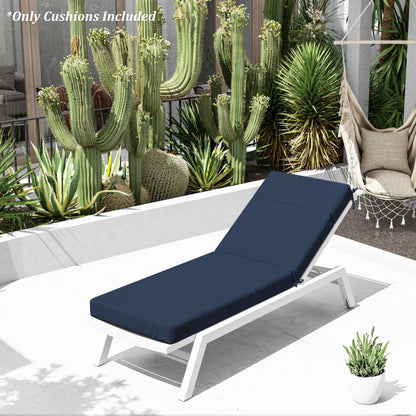 White lounge chair with navy cushion on a patio with cacti and plants in the background