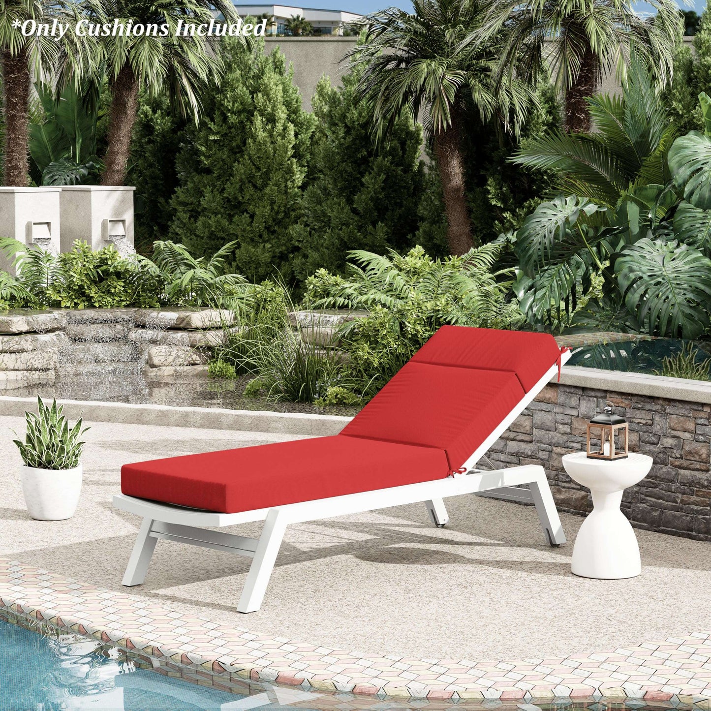 Red cushioned lounge chair by a pool with palm trees and garden in the background