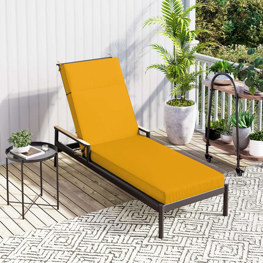 Yellow outdoor lounge chair on a patio with plants and a small table.