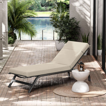 Beige lounge chair on a wooden deck with plants and a pool view