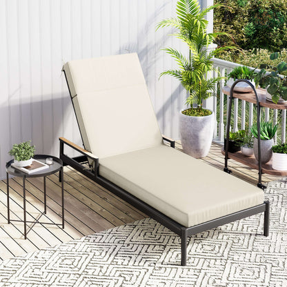 Beige lounge chair on a balcony with plants and a small table.