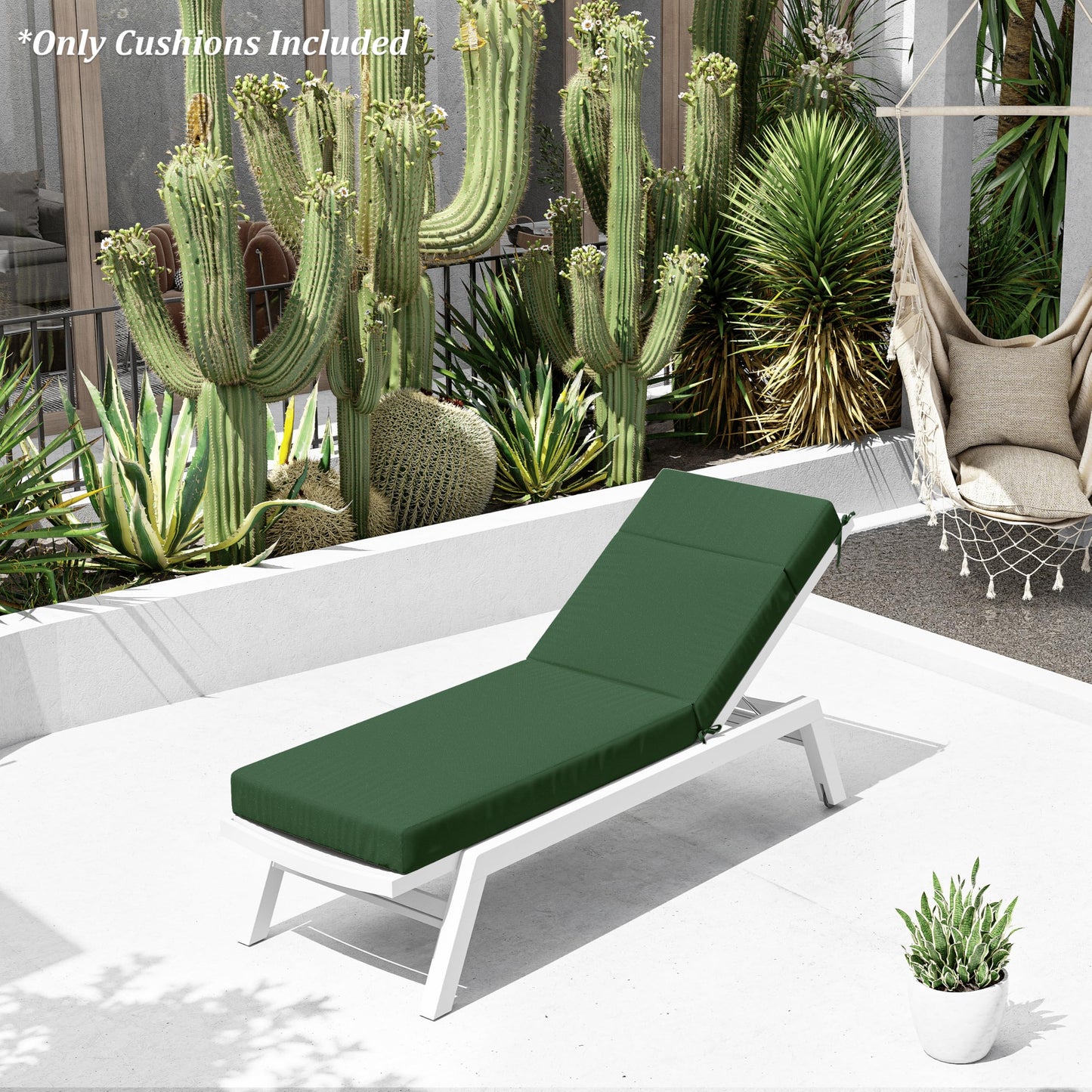 Green cushioned lounge chair on a patio with cacti and plants in the background