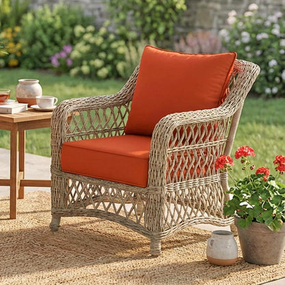 orange red cushions on a wicker chair in the patio with tea and flowers