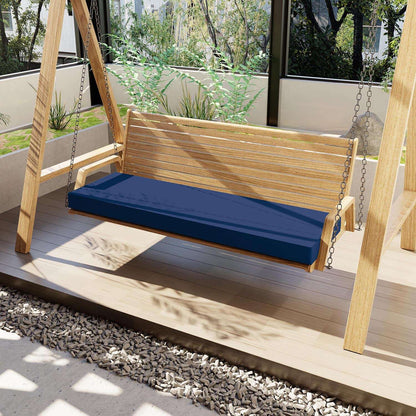 Wooden swing with a blue cushion on a wooden deck
