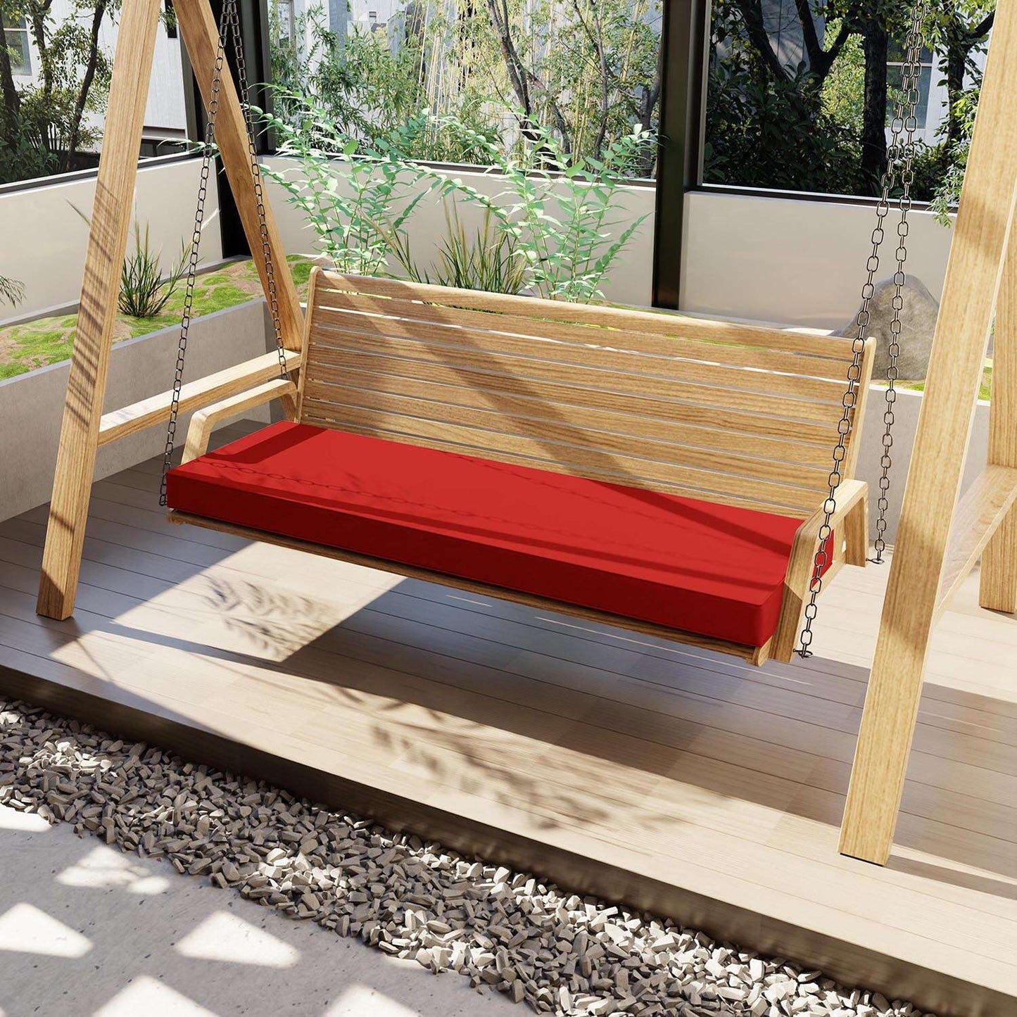 Wooden swing with a red cushion on a wooden deck