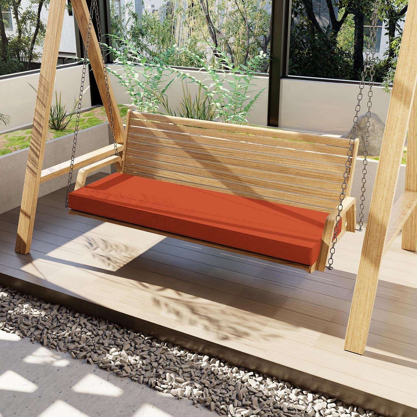 Wooden swing with an orange cushion on a wooden deck