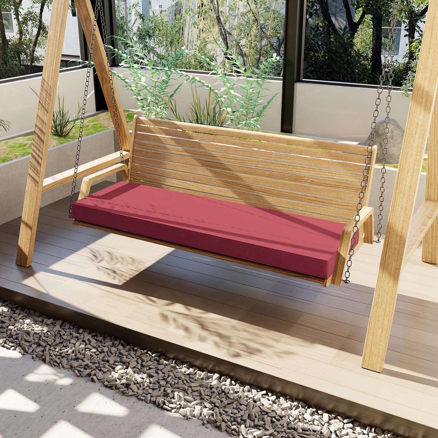Wooden swing with a red cushion on a wooden deck