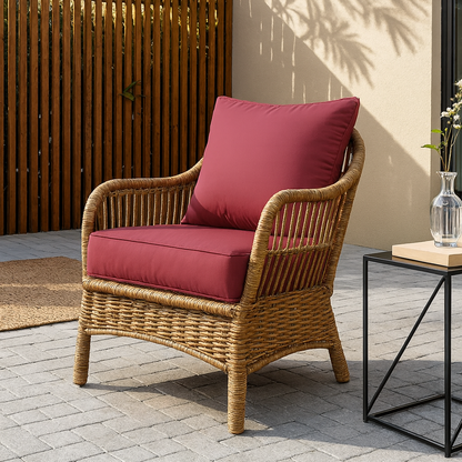Wicker chair with fuchsia red cushions on a patio