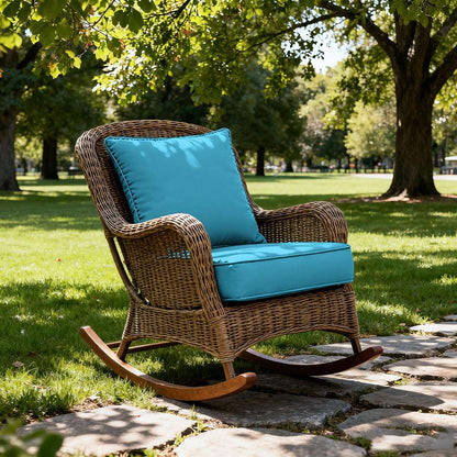 Wicker rocking chair with blue cushions in a park setting