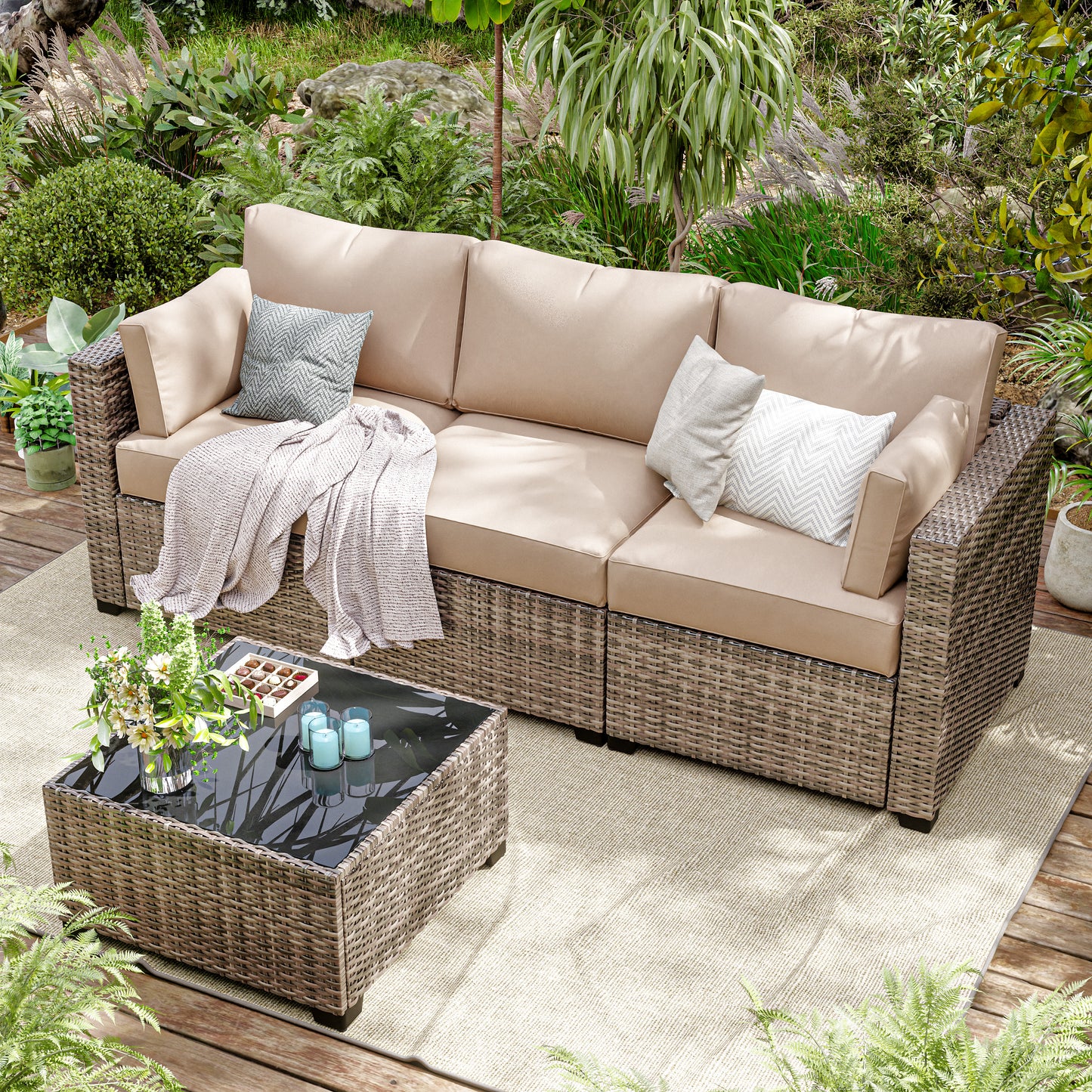 Outdoor patio set with beige sofa, coffee table, and cushions in a garden setting.