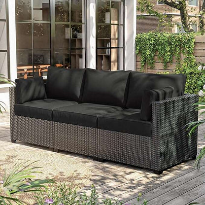 Modern outdoor three-seat sofa with black cushions and woven rattan frame on wooden patio