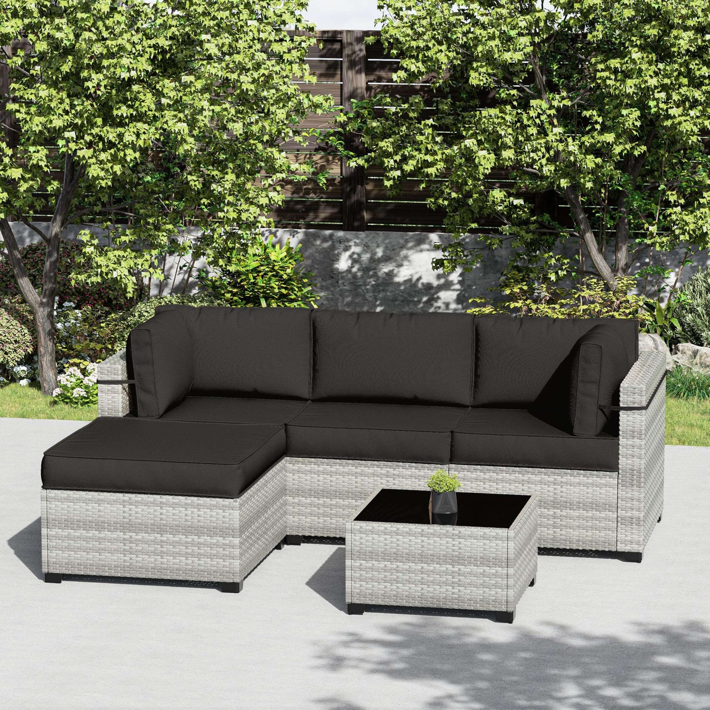 Modern gray wicker outdoor sectional sofa with black cushions and matching coffee table on patio