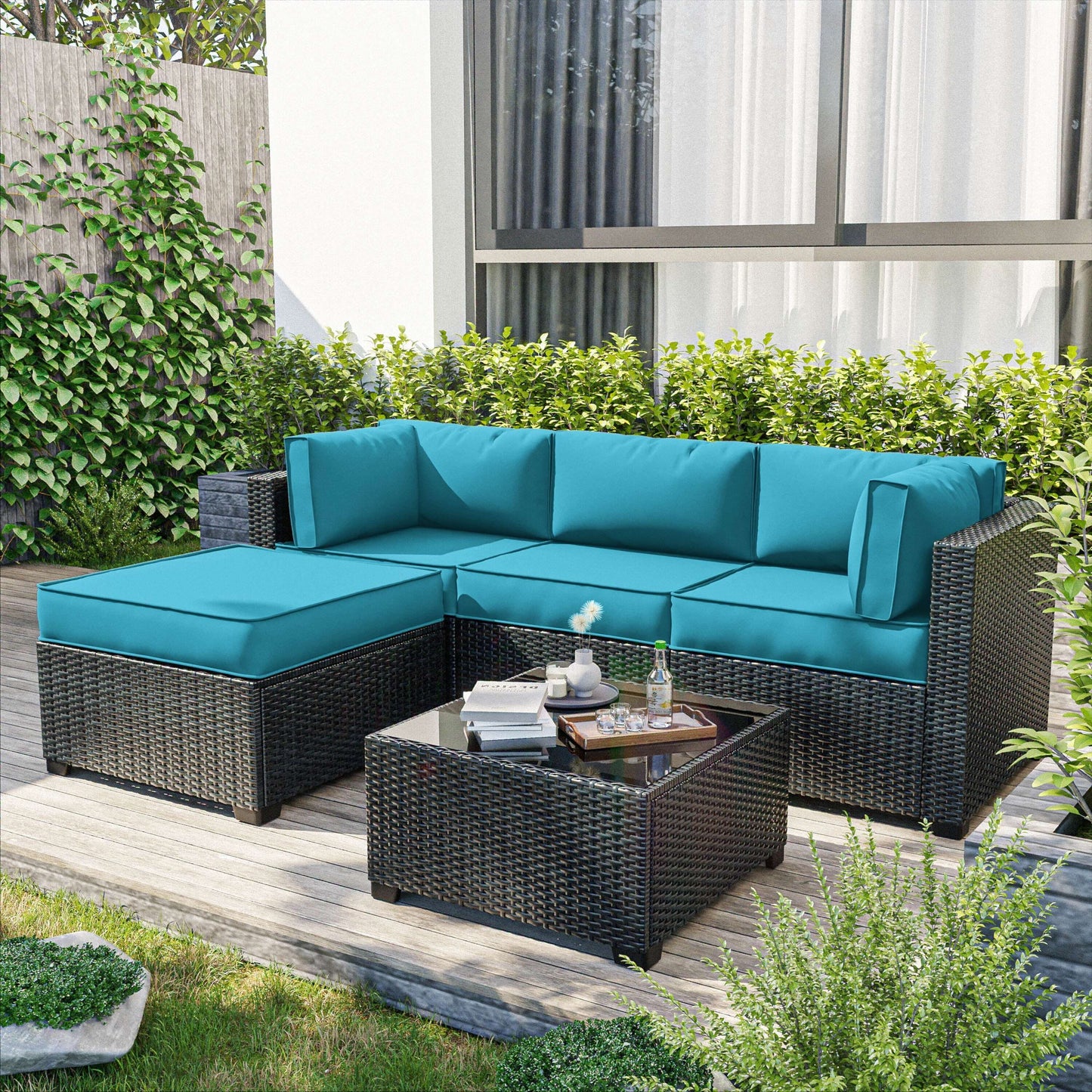 Outdoor rattan corner sofa with lake blue cushions and matching coffee table on wooden deck