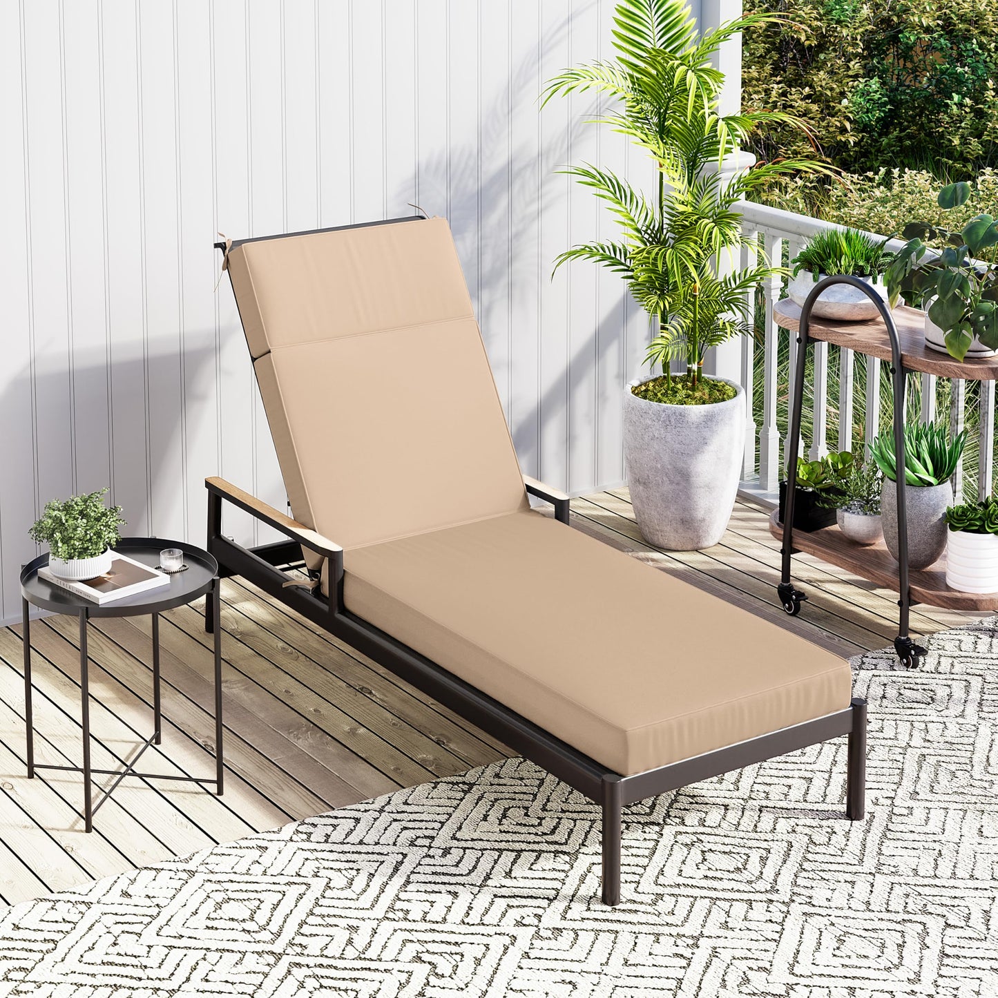Beige cushion on outdoor lounge chair on a patio with plants and a small table.