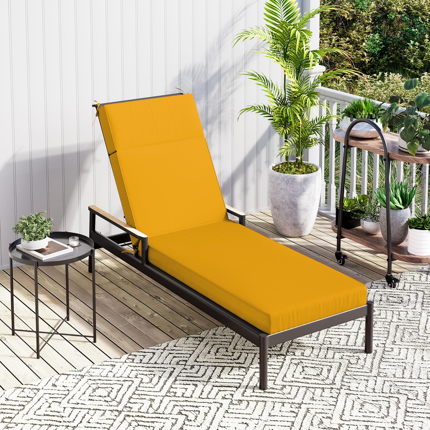 Yellow outdoor lounge chair on a patio with plants and a small table.